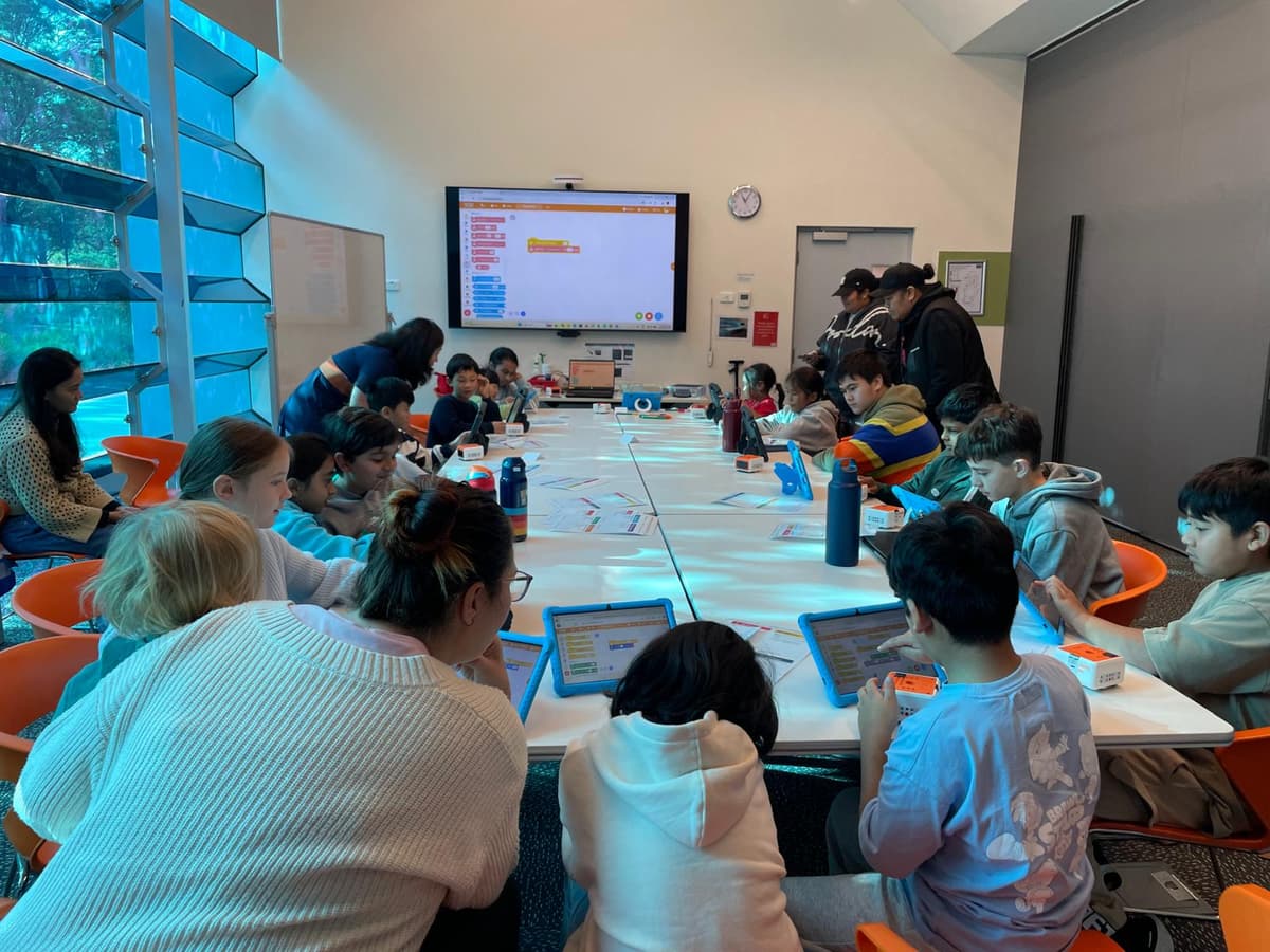 A full room of kids coding their own games in MakeCode Arcade at a ThinkerLab workshop in Caroline Springs