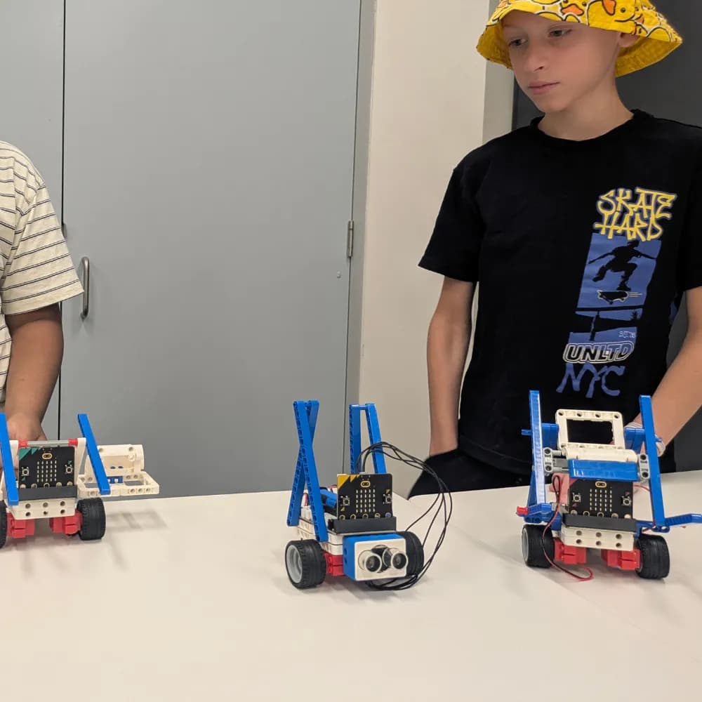 Kids lining up the robots they built, ready to race at a ThinkerLab holiday workshop in Melbourne