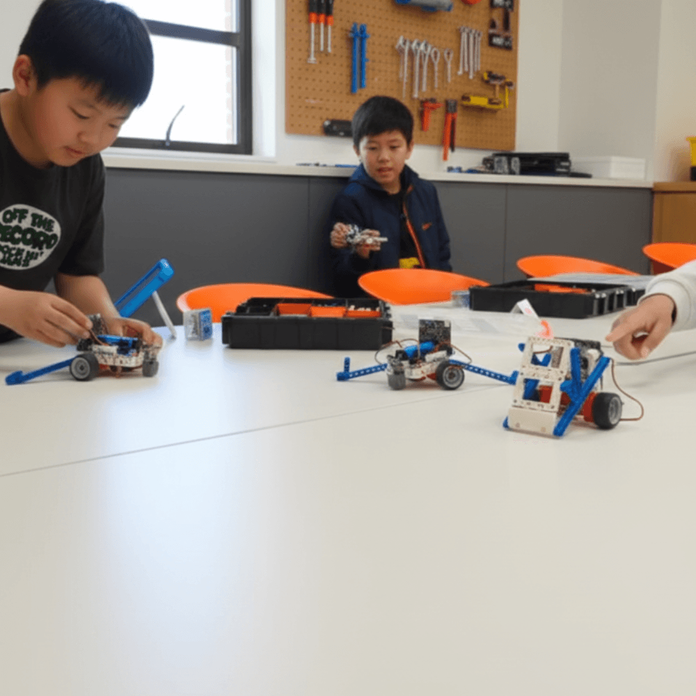 Two children building a robot together at a ThinkerLab school holiday coding workshop in Melbourne