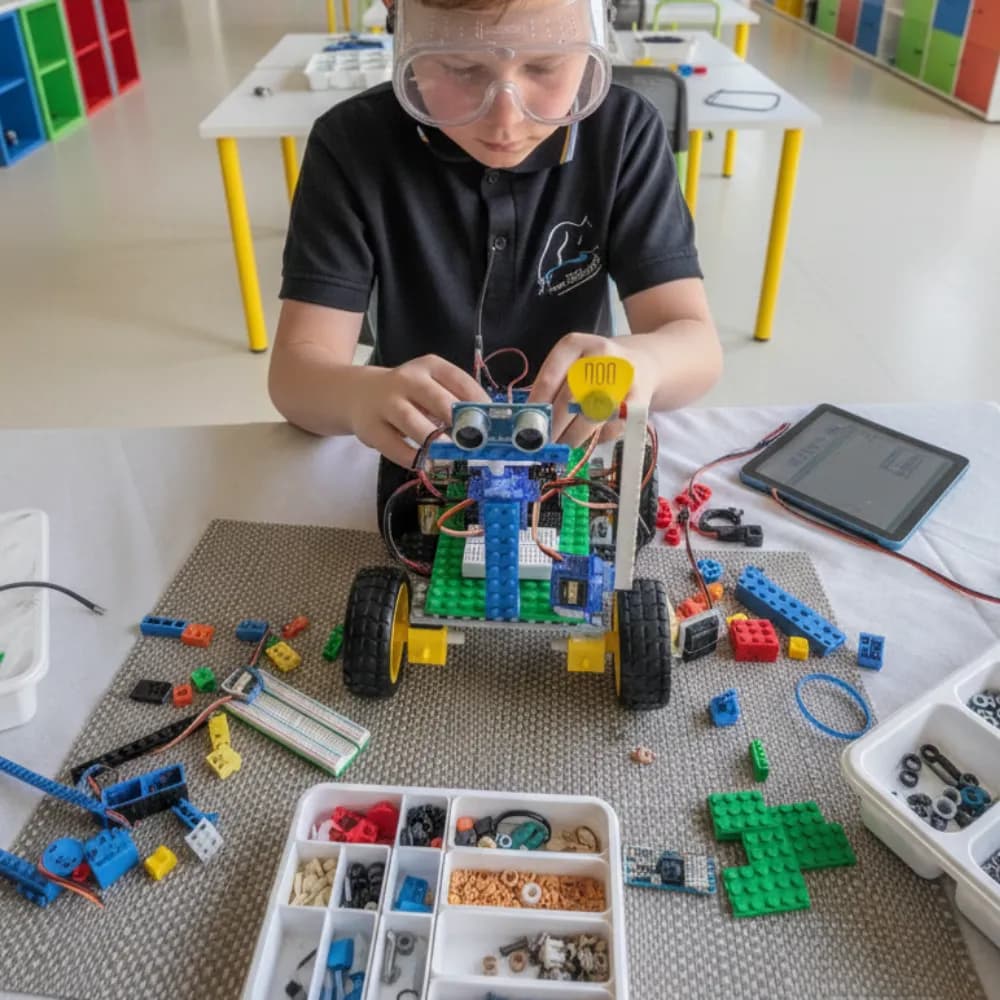 The Robot Isn't the Lesson A young child absorbed in building a robot rover at a ThinkerLab session in Melbourne